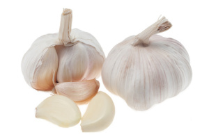 Garlic head and cloves on white background