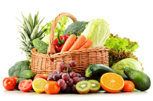 Wicker basket with groceries isolated on white