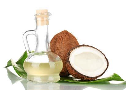 decanter with coconut oil and coconuts isolated on white